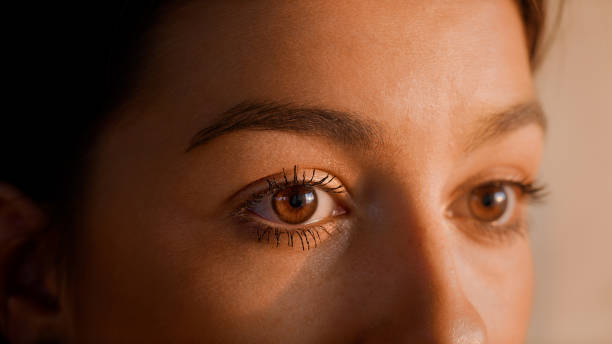 Close-up of a woman's eyes in soft lighting