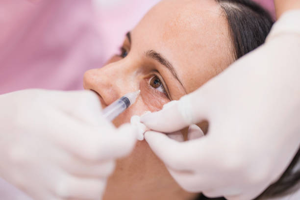 Woman receiving an under-eye treatment injection at a cosmetic clinic