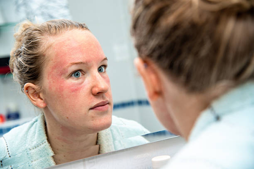 Woman examining her facial skin condition in mirror